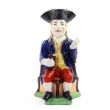 A late 19thC Sampson character jug modeled as The Squire, pipe lacking, modeled seated on a triform