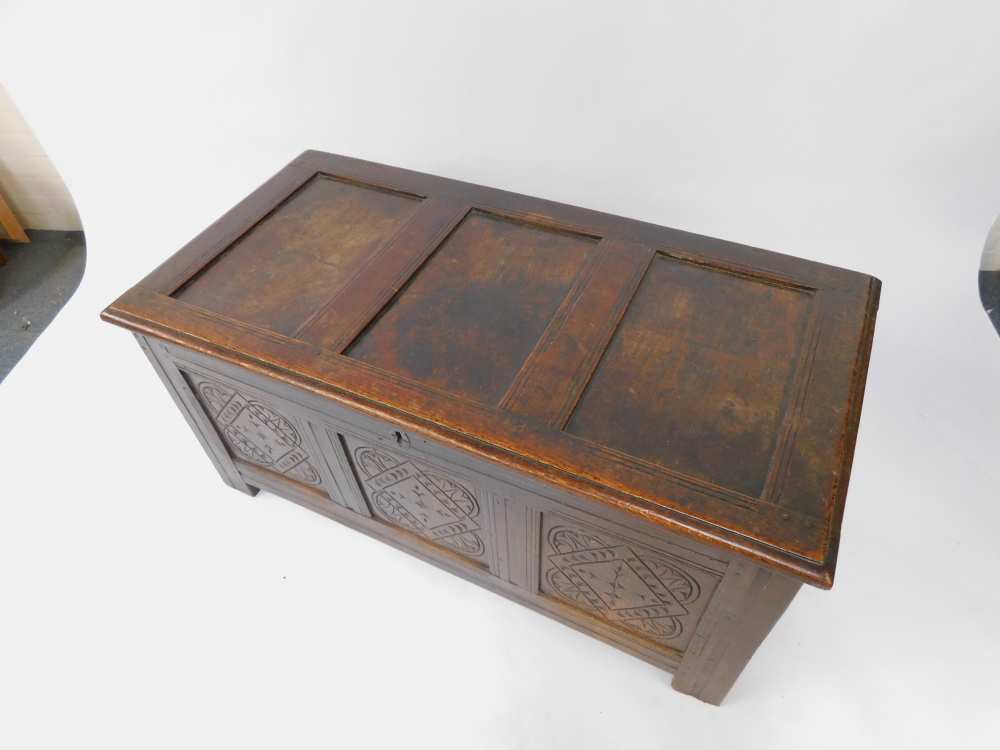 An 17thC oak blanket box, with a carved triple panelled front, raised on channeled square legs, 55cm - Image 2 of 6