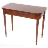 A late Georgian mahogany crossbanded and line inlaid fold over demi lune card table, raised on turne
