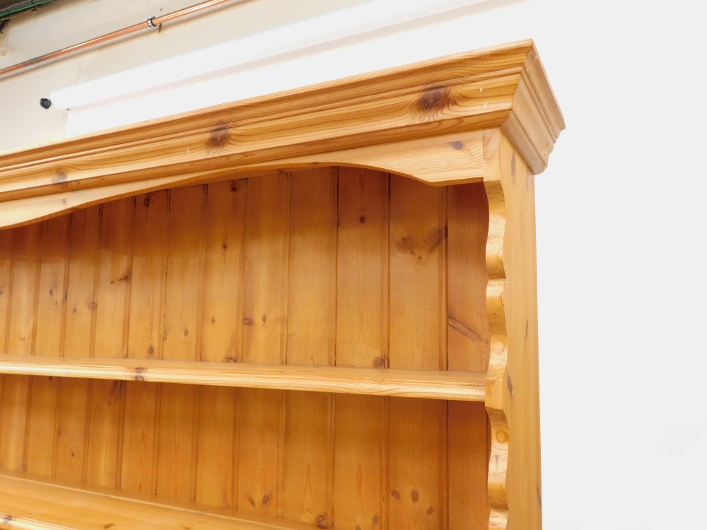 A pine dresser, the outswept pediment over a three shelf plate rack, above five short drawers, over - Image 3 of 4