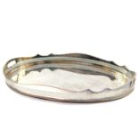 A silver plated oval twin handled galleried tray, 62.5cm wide, 40cm deep.