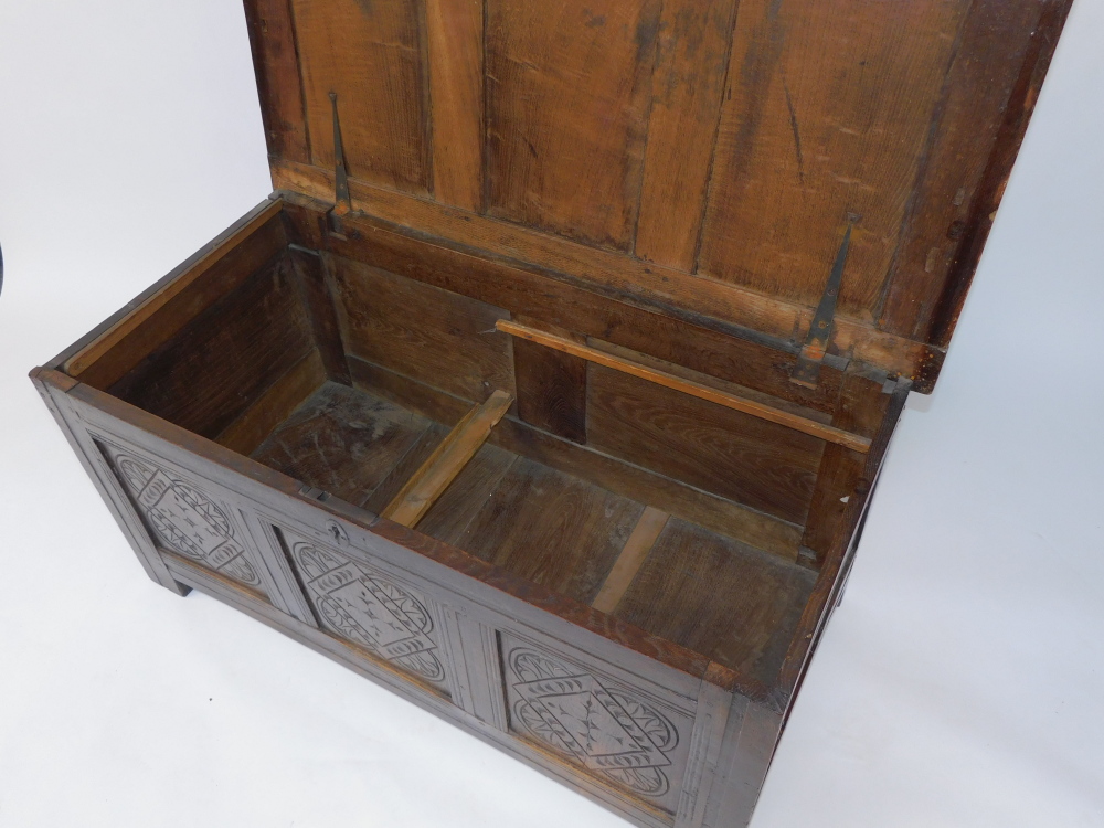 An 17thC oak blanket box, with a carved triple panelled front, raised on channeled square legs, 55cm - Image 6 of 6