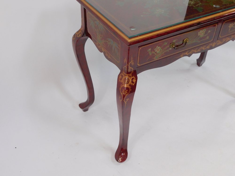 A Chinese painted red lacquer side table, decorated with flowers, with two frieze drawers raised on - Image 3 of 4