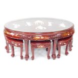A Chinese red lacquer and 'Shibyama' oval coffee table, decorated with figures and pagodas in a gard