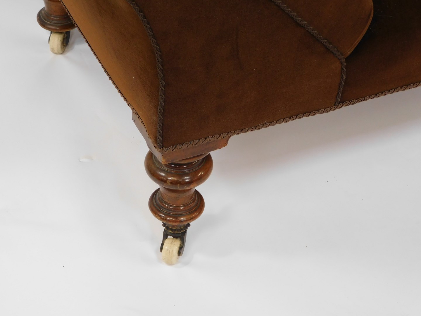 A Victorian mahogany chaise longue, upholstered in brown velour, raised on turned legs, brass capped - Image 2 of 4