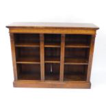 A Victorian walnut and satin wood cross banded open bookcase, with six open shelves, and four column