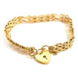 A 9ct gold three bar fancy link gate bracelet, on a heart shaped padlock clasp, with safety chain as