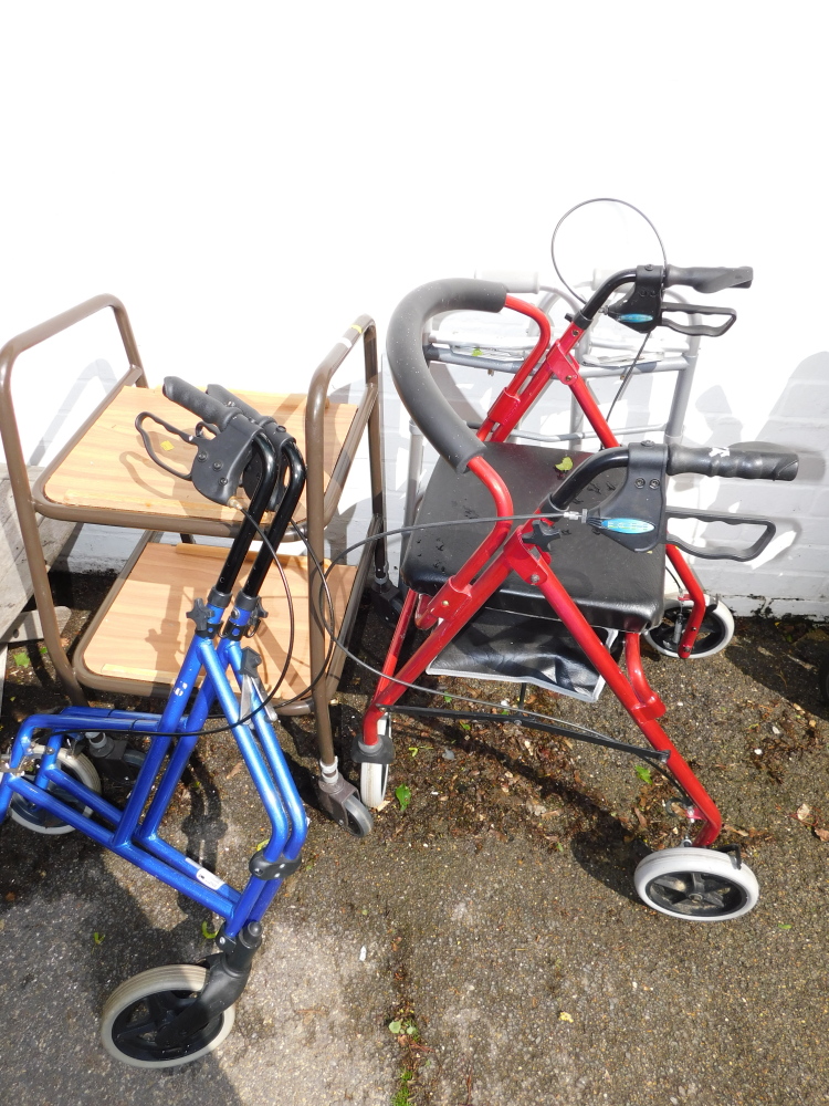 A metal framed mobility walker, with tray, and a other mobility aides. (4)