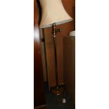 A brass articulated standard lamp, with cream shade, 148cm high.