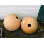 A pair of decorative gable orbs, sandstone finish.