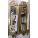 A pair of gilt and gesso wall scones, with rectangular mirrors above brass candle holders.