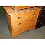 An early 20thC American walnut chest of three drawers, with brass sunken handles, 80cm high, 93cm wi