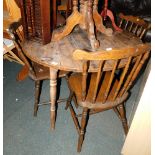 A circular wood effect kitchen table, 72cm high, 106cm diameter, together with four chairs, a wine