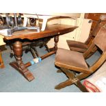 An oak refectory table, together with four X frame chairs. (5) The upholstery in this lot does not c