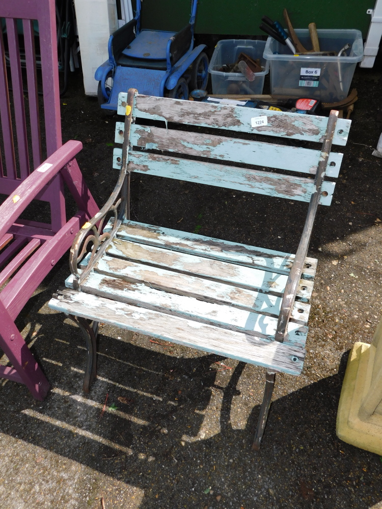 A slatted wrought iron and wooden garden seat.