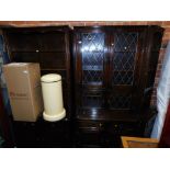 A dark oak three section cabinet, including a corner section, lead glazed middle section, and linen