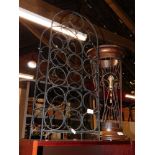 A wire work wine rack, 75cm high, 33cm wide, together with a stained wood and wire umbrella stand, 5