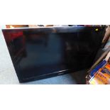 A Samsung wall hanging 32" colour television, model LE37A456C2DXXU, in black trim.