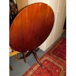 A reproduction mahogany tilt top pedestal table, 76cm high, 90cm diameter.