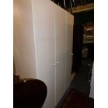 A three section birch effect wardrobe, 210cm high, 13cm wide, 61cm deep.