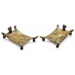 A pair of early 20thC cast bronze desk stands, being card trays formed with an outstretched figure o