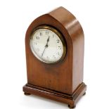 An Edwardian walnut cased lancet mantel clock, the arched domed casing with small circular enamel