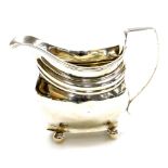 A George III silver sauce boat, part reeded body with reeded handle, bun feet, bearing the initials