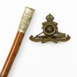 A Royal Engineers swagger stick and a Royal Artillery cap badge (2).