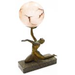 An Art Deco table lamp, in the form of a bronzed patination spelter figure of a kneeling female, on