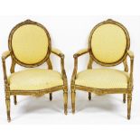 A pair of early 19thC French style gilt painted hall chairs, each with a yellow diamond upholstered