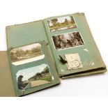 Two Edwardian postcard albums and contents, to include black and white and coloured postcards of cit