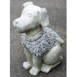 A reconstituted stone garden ornament of a dog, with a side pebble decoration, 60cm high.