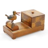 An early 20thC Japanese parquetry cigarette dispenser, with a bird picker, 18cm wide.