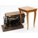 A marquetry sewing table, with musical lift top and a cased sewing machine (2).