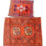 Two middle Eastern prayer rugs, to include one with stag and medallion border and Greek key surround