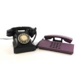 Two vintage telephones, to include a black dial telephone and a PTT Telecom purple retro telephone.