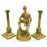 A pair of late 19thC brass Corinthian column candlesticks, 23cm high, and a cast brass figure of a M