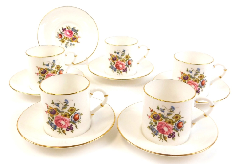 A part set of Royal Worcester coffee cans, comprising six saucers with gilt decoration and floral de