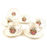 A part set of Royal Worcester coffee cans, comprising six saucers with gilt decoration and floral de