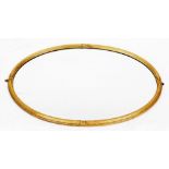 An early 20thC oval gilt framed wall mirror, with oval plate on gilt border with reeded and crossed