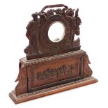 A continental carved wooden timepiece case, the top with central glass panelled section for either a