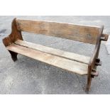 A wooden bench, with notch and slat design, 80cm high, 154cm wide, 46cm deep.