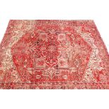 A middle Eastern red ground rug, with medallion border and central Greek key style medallion, with c