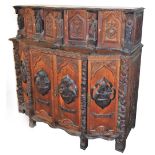 A continental oak serpentine sideboard, with various extensively carved panels doors and figures, wi