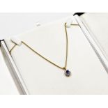 An 18ct gold sapphire and diamond pendant and chain, the sapphire pendant with central cornflower bl