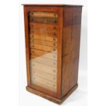 A Victorian collectors chest, with single glazed door, revealing a selection of thirteen numbered dr