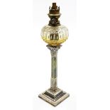A late19thC silver plated oil lamp, the glass reservoir above a silver plated taped and rococo sc