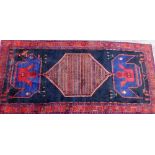 A deep blue ground rug, with large central medallion, on Greek key borders, with patch repair, 323cm