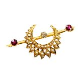 An Eastern inspired bar brooch, set with diamond, ruby and applied crescent moon and flower set seed
