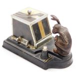 A Ronson 'Pik-a-Cig" Art Deco cigarette dispenser, in the form of a grabbing monkey, 13cm high, 21cm